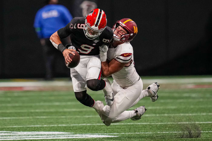 Oct 15, 2023; Atlanta, Georgia, USA; Atlanta Falcons quarterback Desmond Ridder (9) is tackled for a loss by Washington Commanders defensive end Casey Toohill (95) during the second half at Mercedes-Benz Stadium. Mandatory Credit: Dale Zanine-USA TODAY Sports